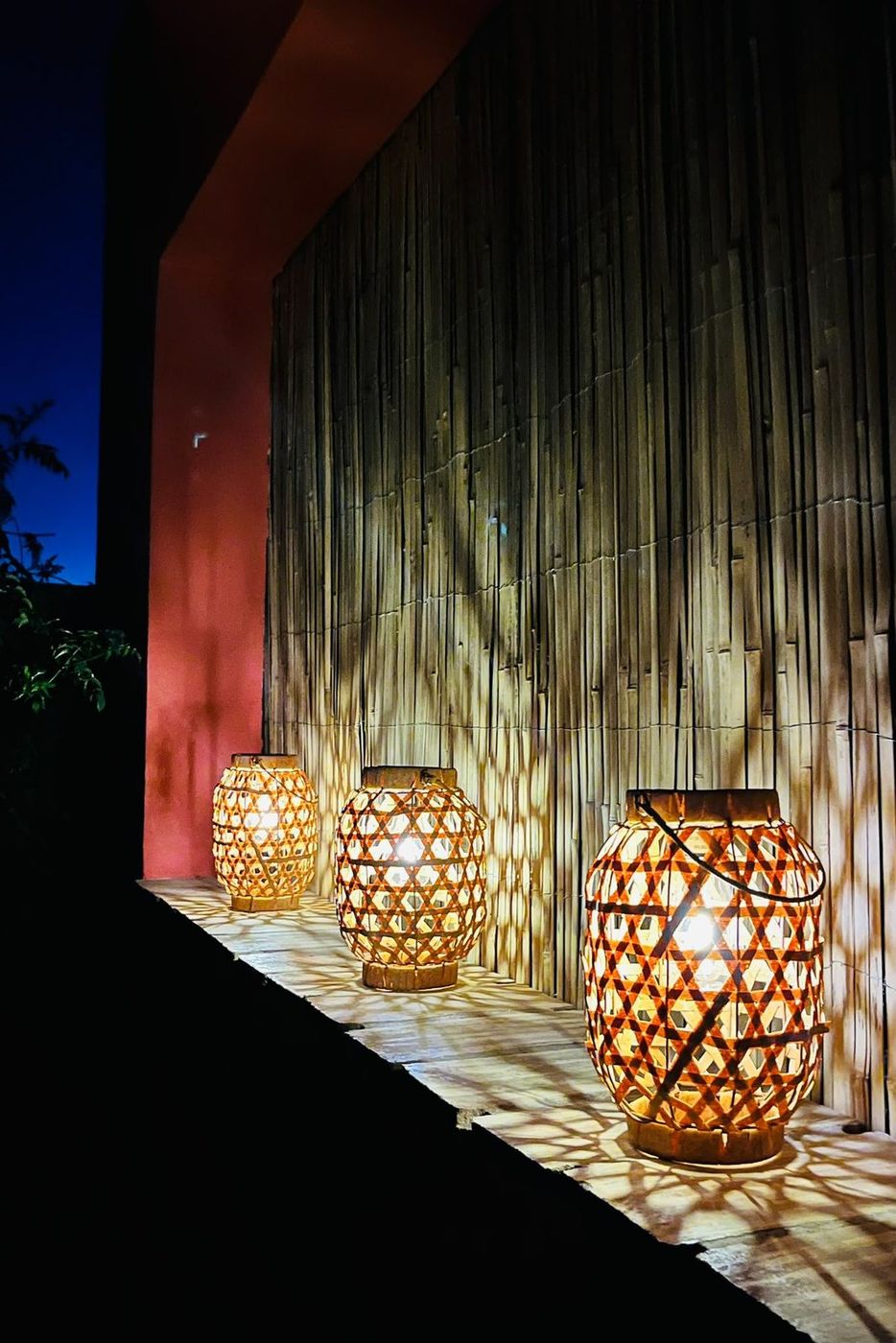 Lanterns along the bamboo wall at dusk
